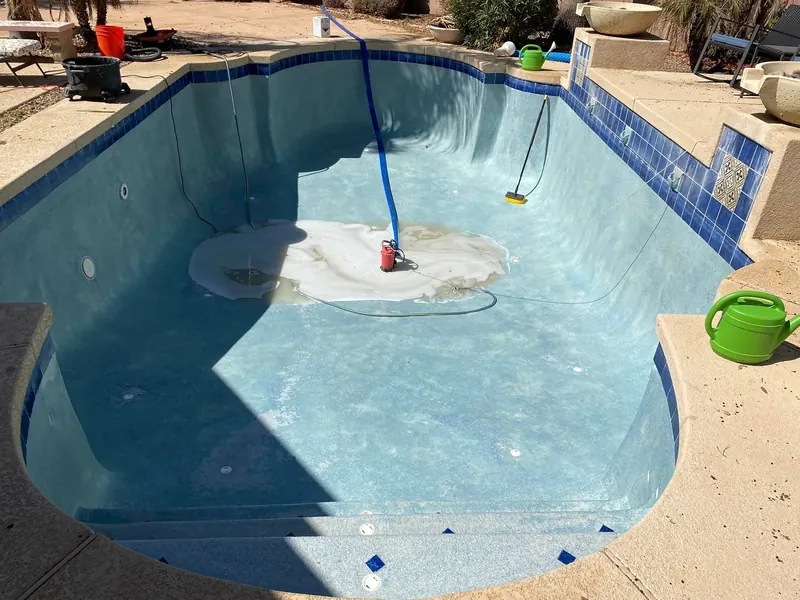 An empty pool, drained so the surface can be cleaned and the water replaced